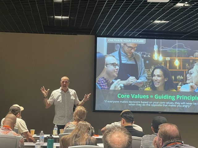 David Scott Peters coaching restaurant owners on stage at the workshop